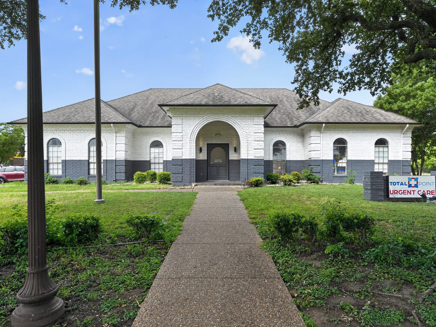 The arched front entrance of 108 Erwin Drive with a landscaped walkway
